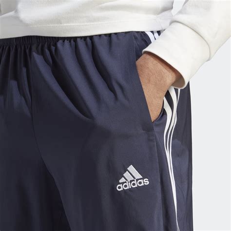 adidas assential 3 stripes donkerblauw heren|adidas Sportswear ESSENTIALS TAPERED CUFF 3 STRIPES .